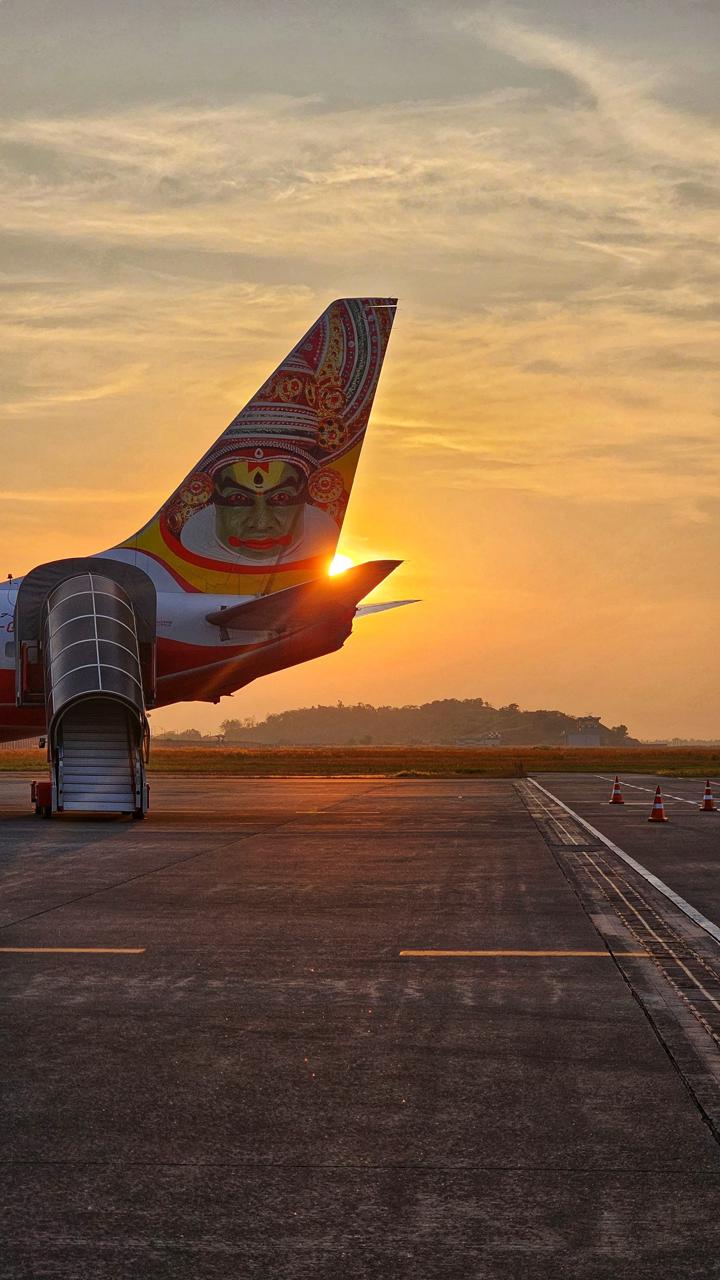 Aircraft tail fin at sunset on the Kannur International Airport apron